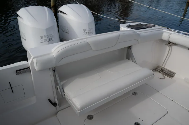 Slide: The Image of 2019 Everglades 295 Center Console boat with Yamaha 300 engines, featuring a foldable rear seat. - 39