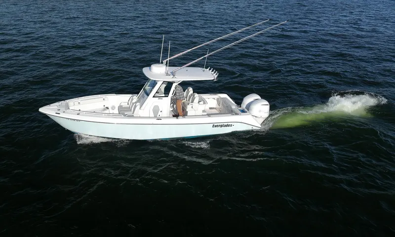 Slide: The Image of 2019 Everglades 295 Center Console boat cruising on open water. - 4
