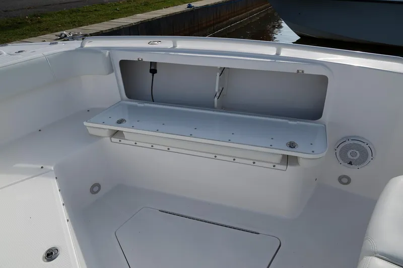Slide: The Image of 2019 Everglades 295 Center Console boat interior with storage compartment and seating area. - 43