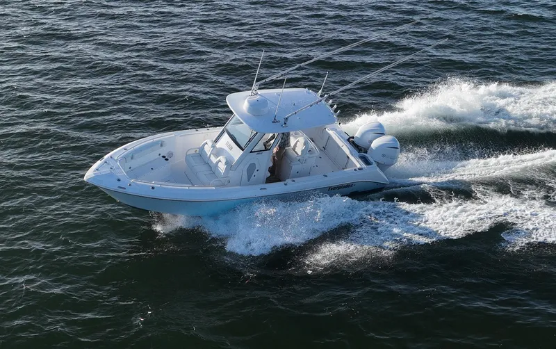 Slide: The Image of 2019 Everglades 295 Center Console boat cruising on open water. - 5