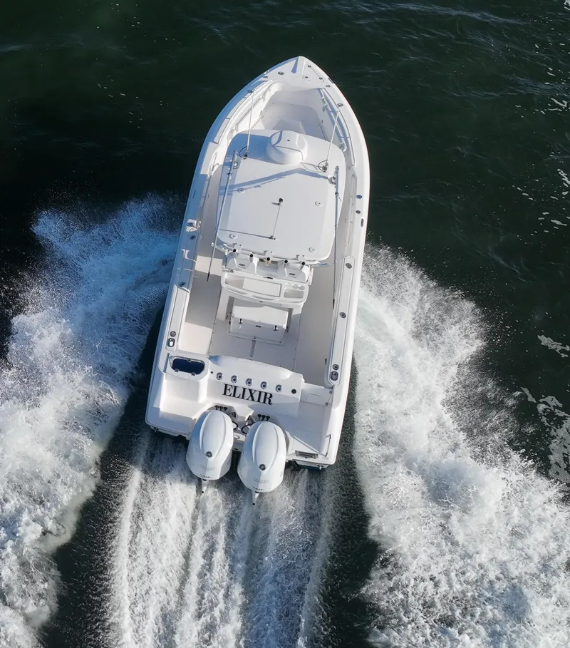 Slide: The Image of 2019 Everglades 295 Center Console boat cruising on water, aerial view. - 6