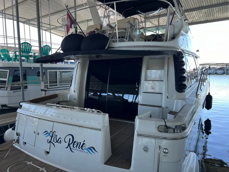 Slide: The Image of 2001 Carver 450 Voyager Pilothouse yacht docked in marina, rear view. - 10
