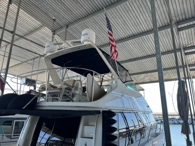 Slide: The Image of 2001 Carver 450 Voyager Pilothouse yacht docked under a covered marina. - 15