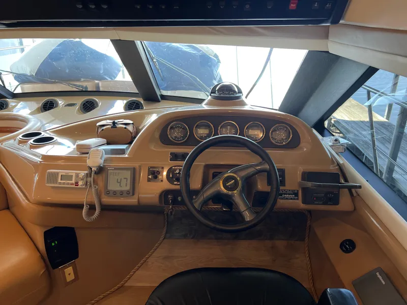 Slide: The Image of Interior cockpit of 2001 Carver 450 Voyager Pilothouse with steering wheel and control panel. - 22