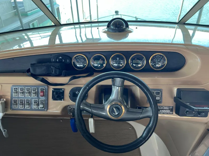 Slide: The Image of 2001 Carver 450 Voyager Pilothouse helm with steering wheel and instrument panel. - 23