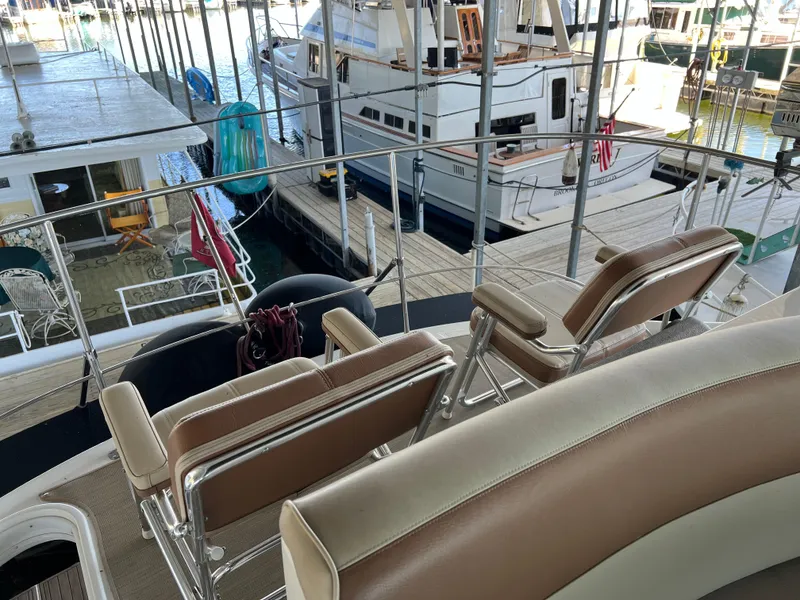Slide: The Image of 2001 Carver 450 Voyager Pilothouse yacht interior with docked boats in marina. - 25