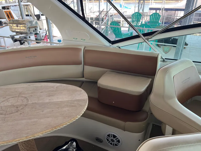Slide: The Image of Interior of 2001 Carver 450 Voyager Pilothouse with beige seating and wooden table. - 27