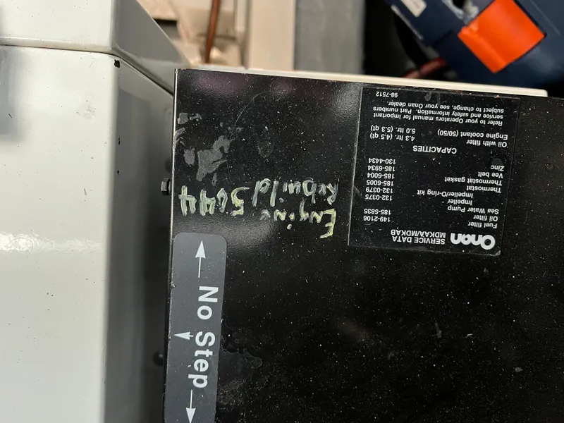 Slide: The Image of Close-up of a 2001 Carver 450 Voyager Pilothouse engine component with "No Step" label. - 29