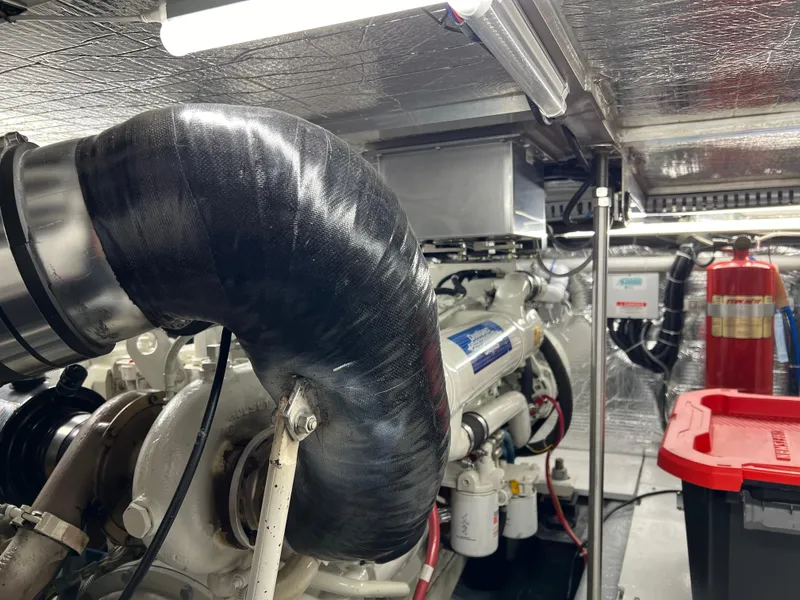 Slide: The Image of Engine room of 2001 Carver 450 Voyager Pilothouse with visible machinery and fire extinguisher. - 36