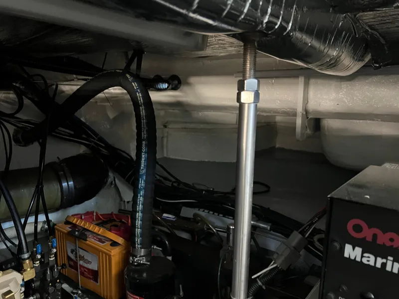 Slide: The Image of Engine room of 2001 Carver 450 Voyager Pilothouse with mechanical components and wiring. - 39