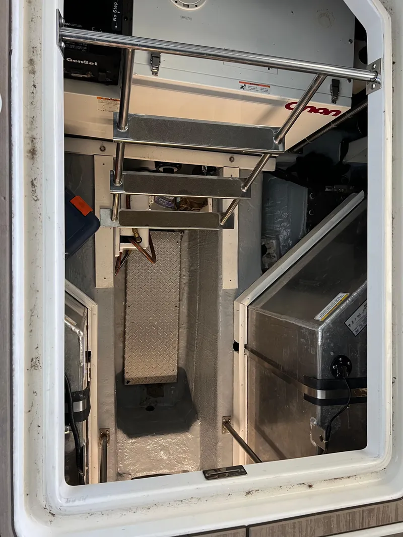 Slide: The Image of Engine room of 2001 Carver 450 Voyager Pilothouse with visible ladder and equipment. - 44