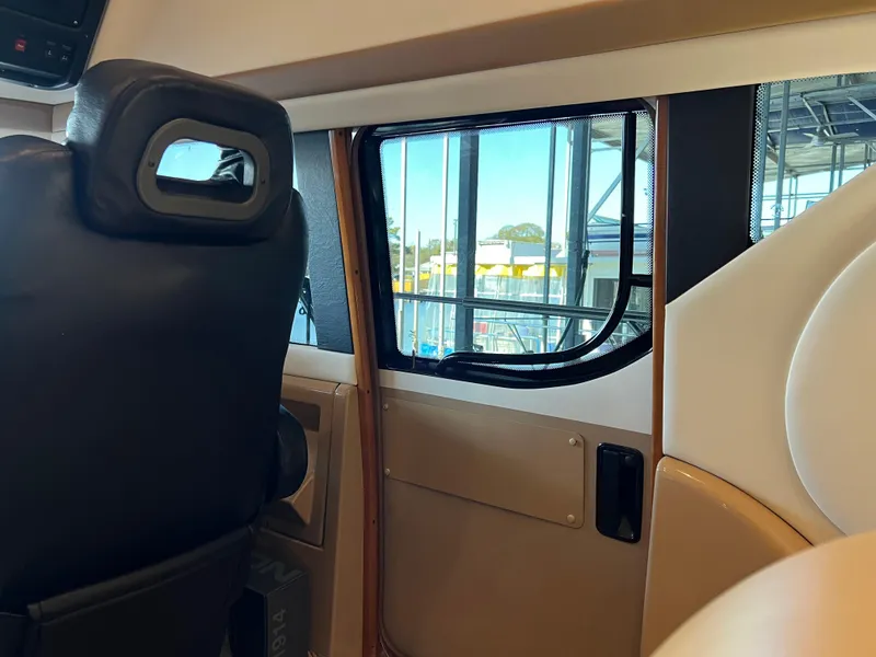Slide: The Image of Interior view of 2001 Carver 450 Voyager Pilothouse, featuring a window and seating area. - 45