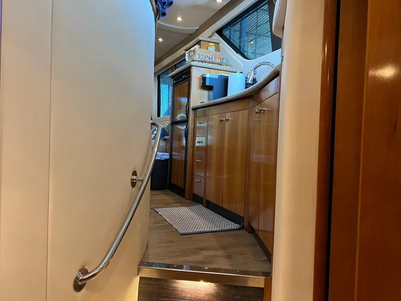 Slide: The Image of Interior of 2001 Carver 450 Voyager Pilothouse yacht with wooden cabinetry and modern amenities. - 46