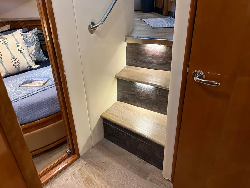 Slide: The Image of Interior of 2001 Carver 450 Voyager Pilothouse with wooden stairs and cozy bedroom. - 47