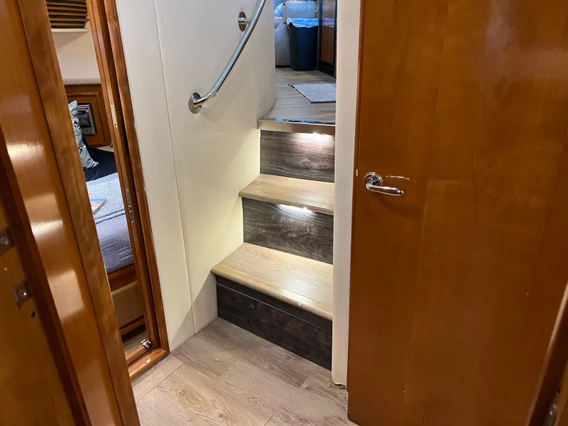 Slide: The Image of Interior stairs of 2001 Carver 450 Voyager Pilothouse with wood finish and handrail. - 48