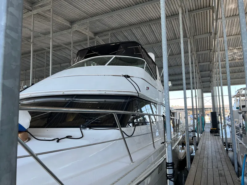Slide: The Image of 2001 Carver 450 Voyager Pilothouse yacht docked in a covered marina. - 8