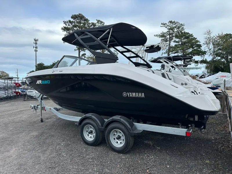 Slide: The Image of 2025 Yamaha AR220 boat on trailer, sleek design, black and white color scheme. - 10