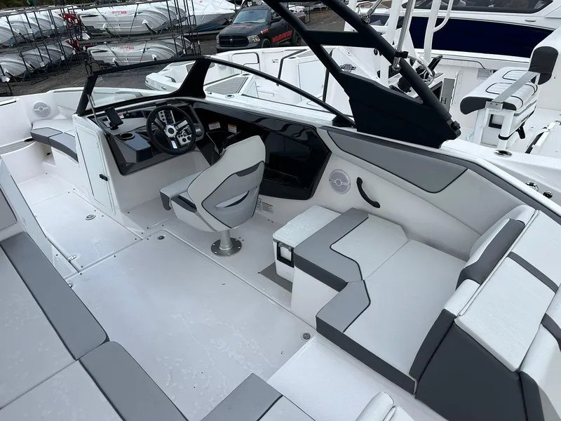 Slide: The Image of 2025 Yamaha Boats AR220 interior with sleek seating and modern dashboard design. - 16