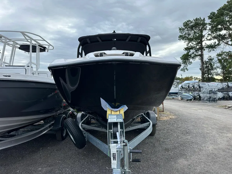 Slide: The Image of 2025 Yamaha Boats AR220 on trailer, parked outdoors under cloudy sky. - 22