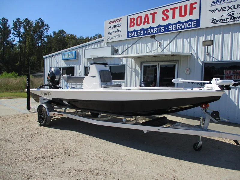 Slide: The Image of 2025 Avid 21 FSX boat on trailer outside dealership. - 1