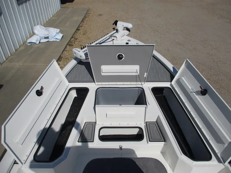 Slide: The Image of 2025 Avid 21 FSX boat with open storage compartments and trolling motor. - 10