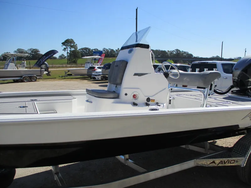 Slide: The Image of 2025 Avid 21 FSX boat on trailer, side view, outdoors. - 4
