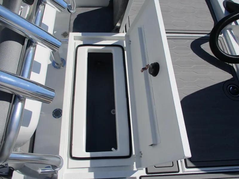 Slide: The Image of Open storage compartment on 2025 Avid 21 FSX boat deck. - 9