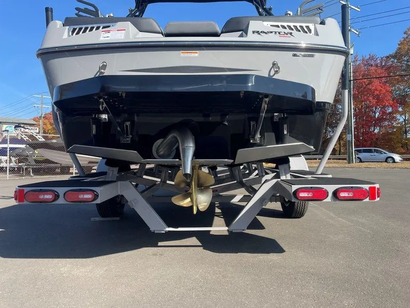 Slide: The Image of 2025 Moomba Mondo boat rear view with trailer, showcasing propeller and hull design. - 11