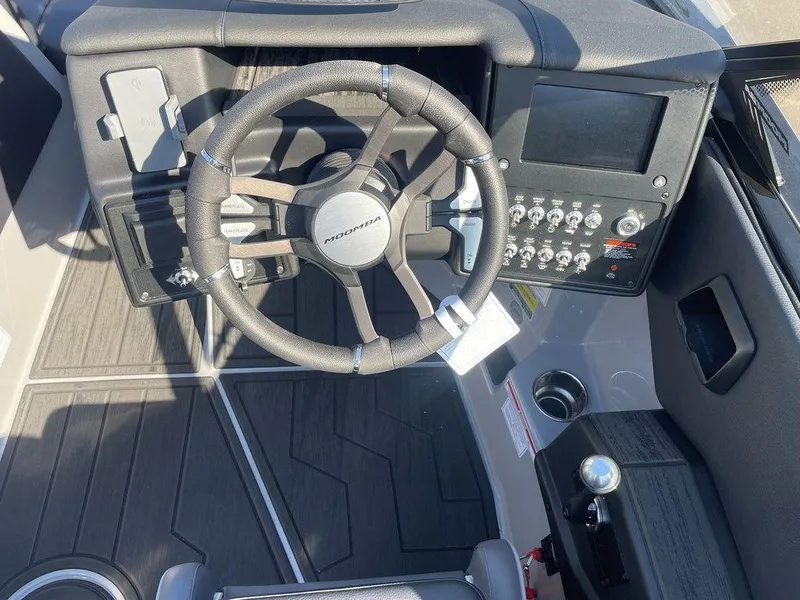 Slide: The Image of 2025 Moomba Mondo boat dashboard with steering wheel and control panel. - 17