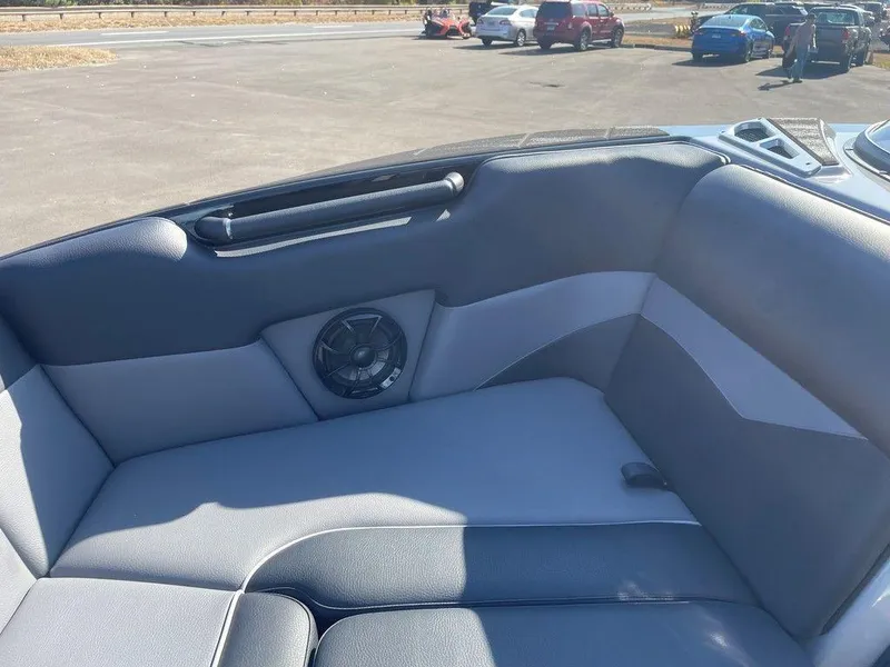 Slide: The Image of 2025 Moomba Mondo boat interior with gray seating and speaker detail. - 22