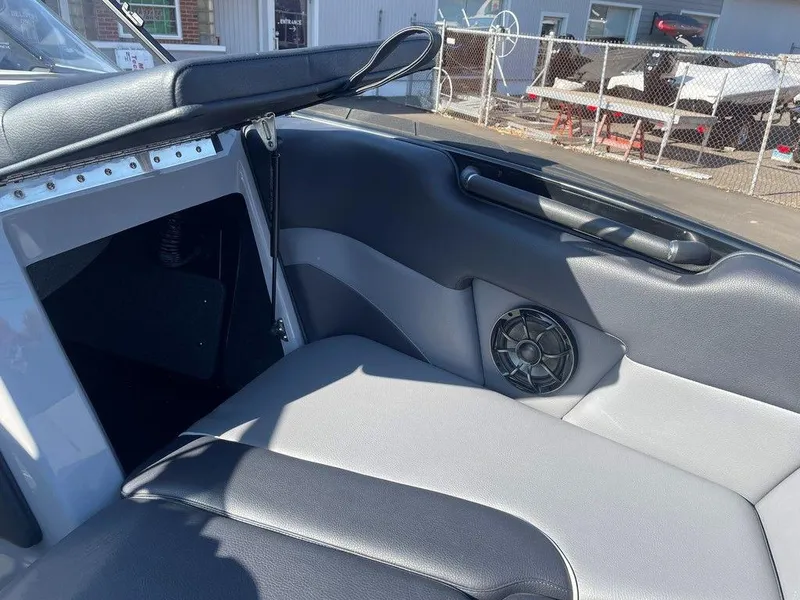 Slide: The Image of 2025 Moomba Mondo boat interior with black and gray seating and speaker detail. - 27