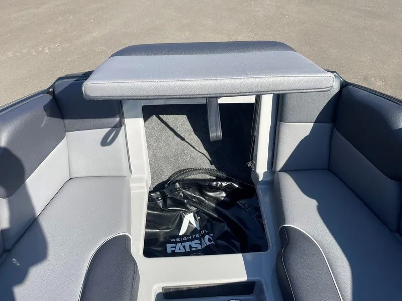 Slide: The Image of 2025 Moomba Mondo boat interior with gray seating and storage compartment. - 28