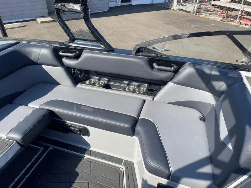 Slide: The Image of 2025 Moomba Mondo boat interior with gray seating and cup holders. - 33