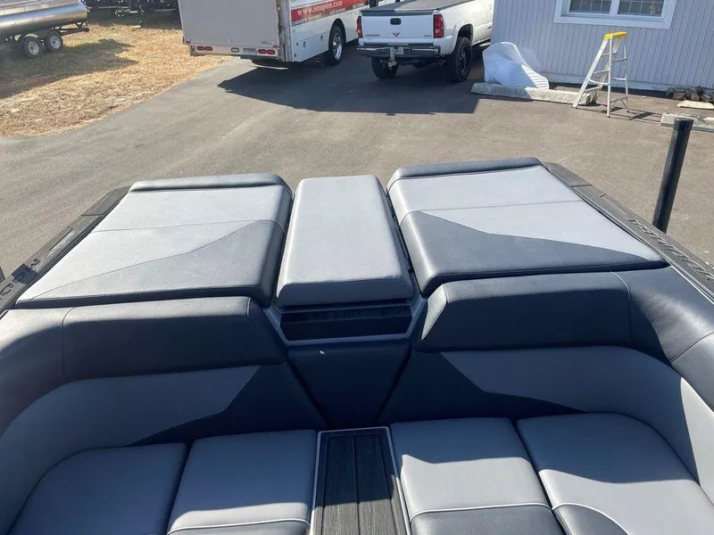 Slide: The Image of 2025 Moomba Mondo boat interior with gray seating and storage compartments. - 34