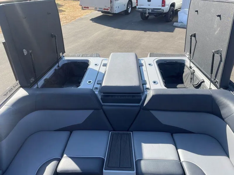 Slide: The Image of 2025 Moomba Mondo boat interior with open storage compartments and cushioned seating. - 37