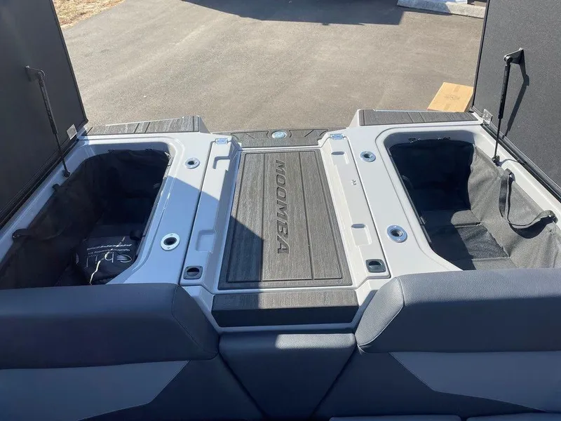 Slide: The Image of 2025 Moomba Mondo boat storage compartments with open hatches on a sunny day. - 38