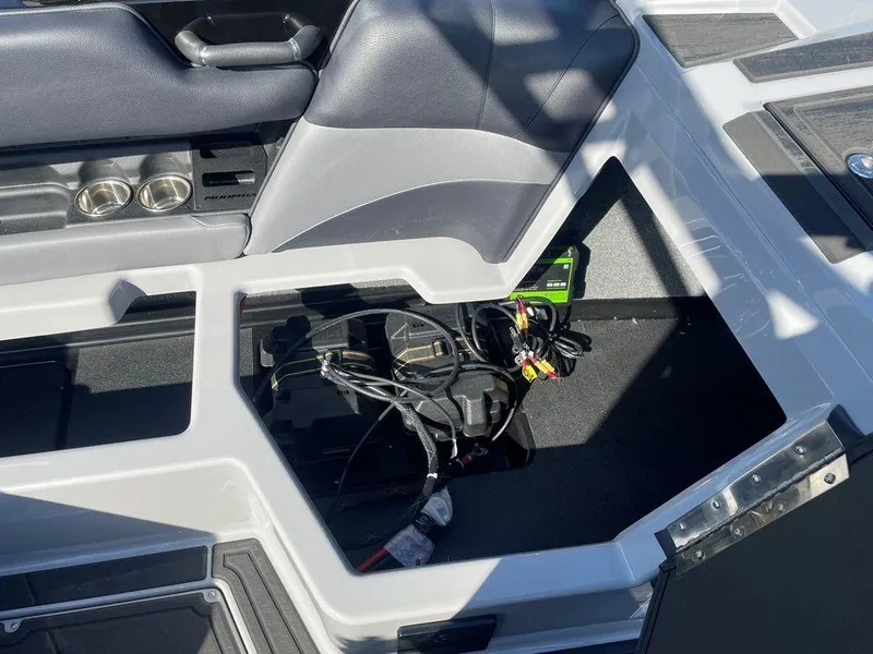 Slide: The Image of 2025 Moomba Mondo boat interior storage compartment with wiring and cup holders. - 41