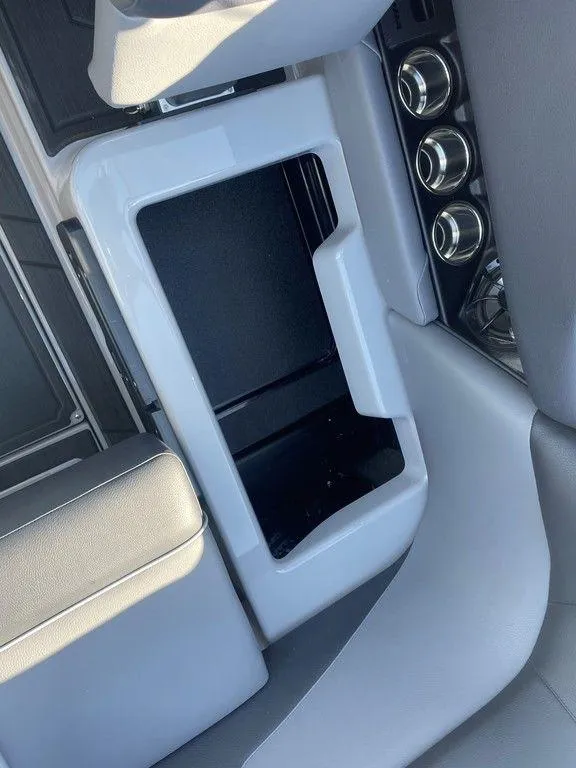 Slide: The Image of 2025 Moomba Mondo boat interior with storage compartment and cup holders. - 42