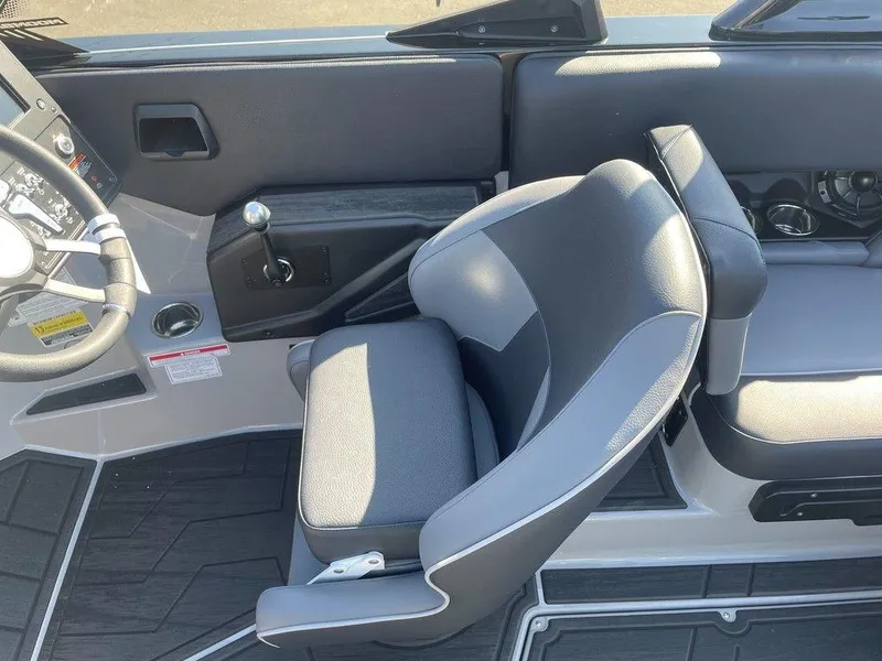 Slide: The Image of 2025 Moomba Mondo boat interior with gray seating and steering wheel. - 43