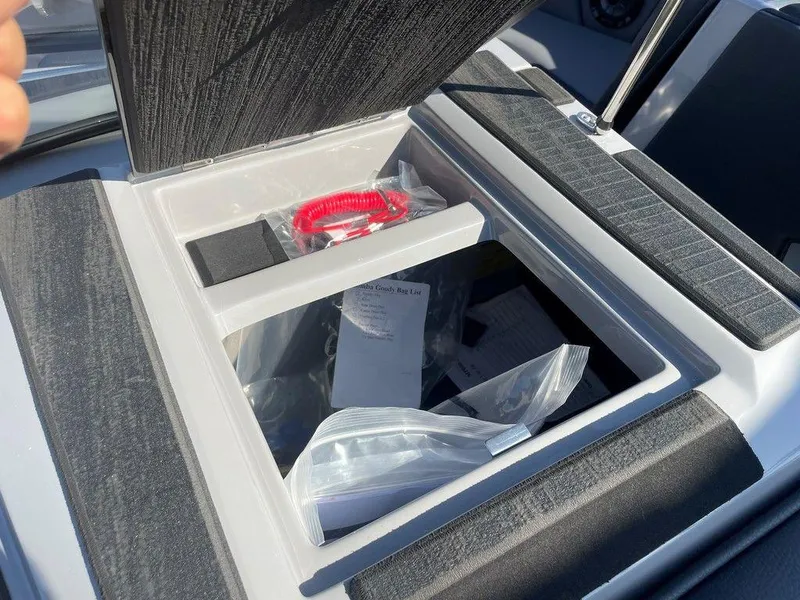 Slide: The Image of Storage compartment in a 2025 Moomba Mondo boat, containing safety equipment and documents. - 45