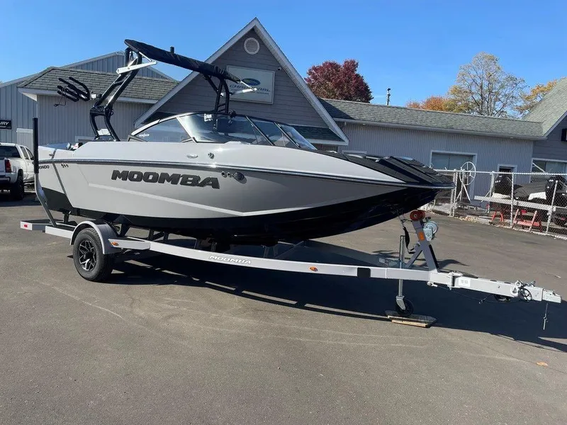 Slide: The Image of 2025 Moomba Mondo boat on trailer, parked outdoors near buildings. - 9