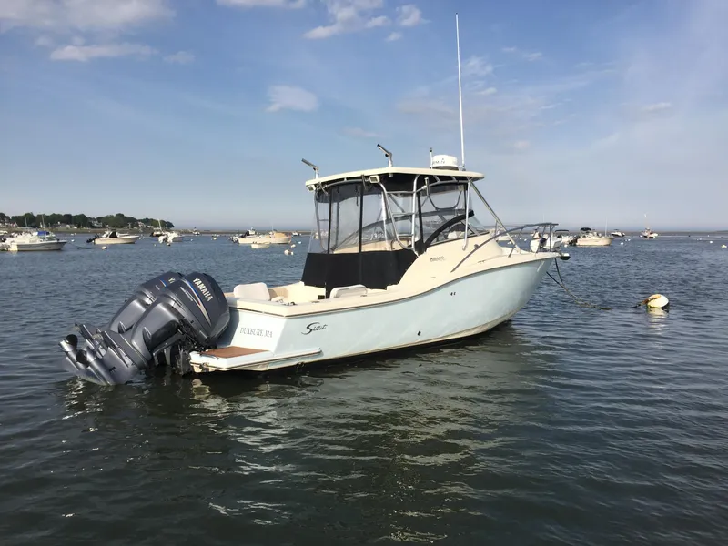 The Image of 2004 Scout 280 Abaco boat on calm water with other boats in the background. - 0