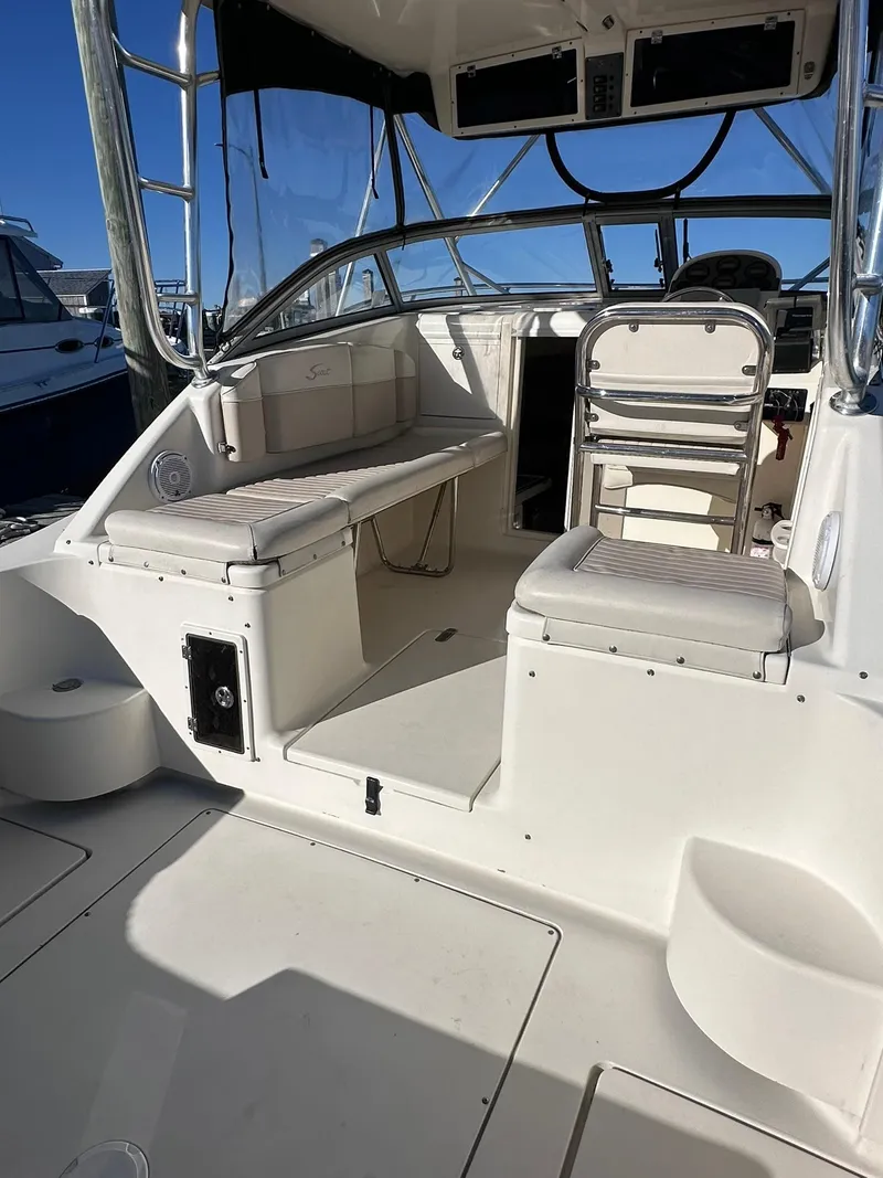 Slide: The Image of 2004 Scout 280 Abaco boat interior with seating and helm, featuring sleek design and spacious layout. - 10