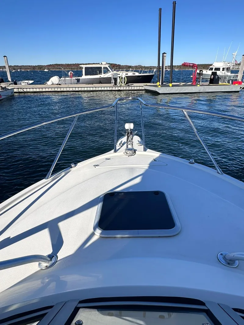 Slide: The Image of 2004 Scout 280 Abaco boat docked at marina, clear blue sky. - 16