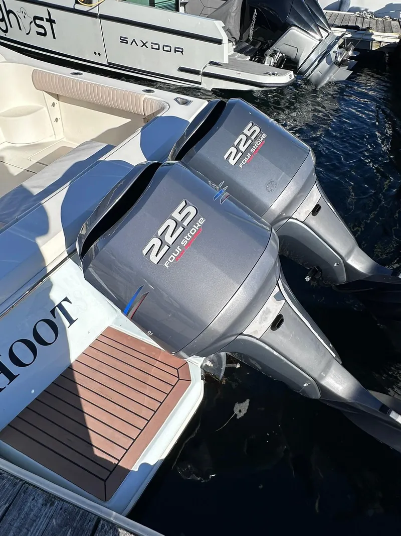 Slide: The Image of 2004 Scout 280 Abaco with twin 225 horsepower outboard engines docked. - 18