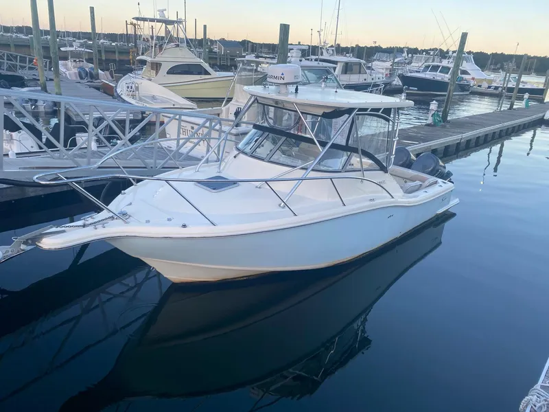 Slide: The Image of 2004 Scout 280 Abaco boat docked in a marina at sunset. - 3