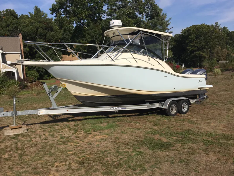 Slide: The Image of 2004 Scout 280 Abaco boat on trailer, parked on grass. - 4