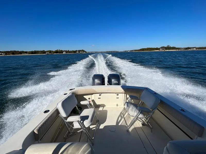 Slide: The Image of 2004 Scout 280 Abaco boat cruising on open water, leaving a wake behind. - 5