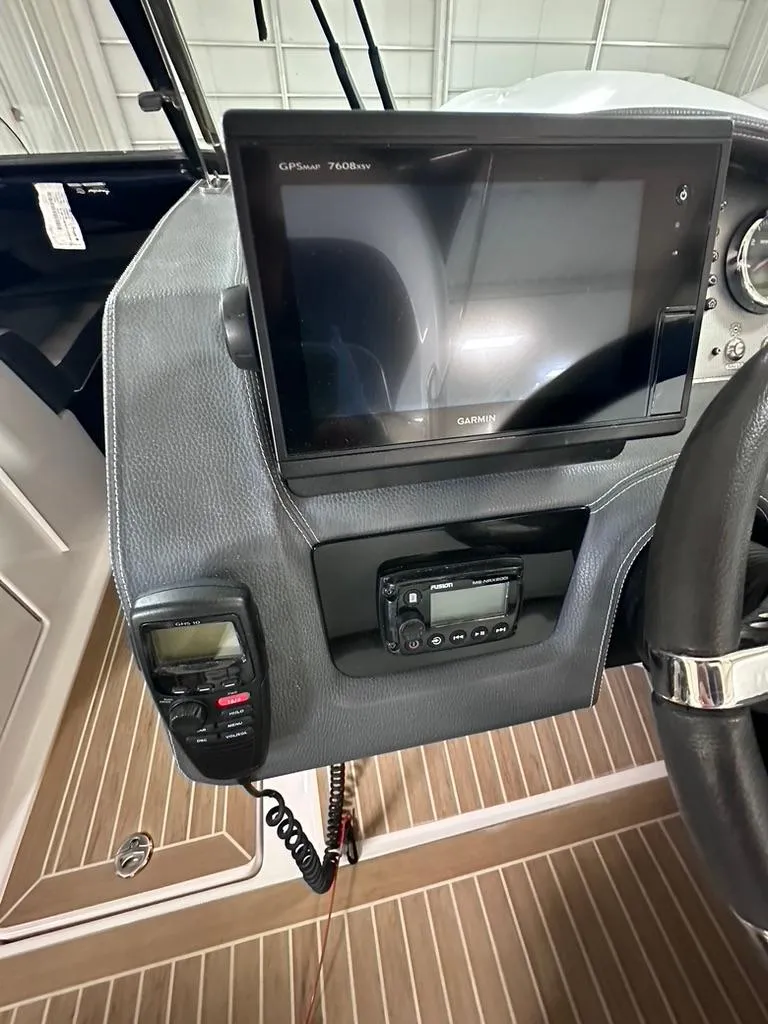 Slide: The Image of 2015 Regal 2800 Bowrider dashboard with Garmin GPS and control panel. - 10