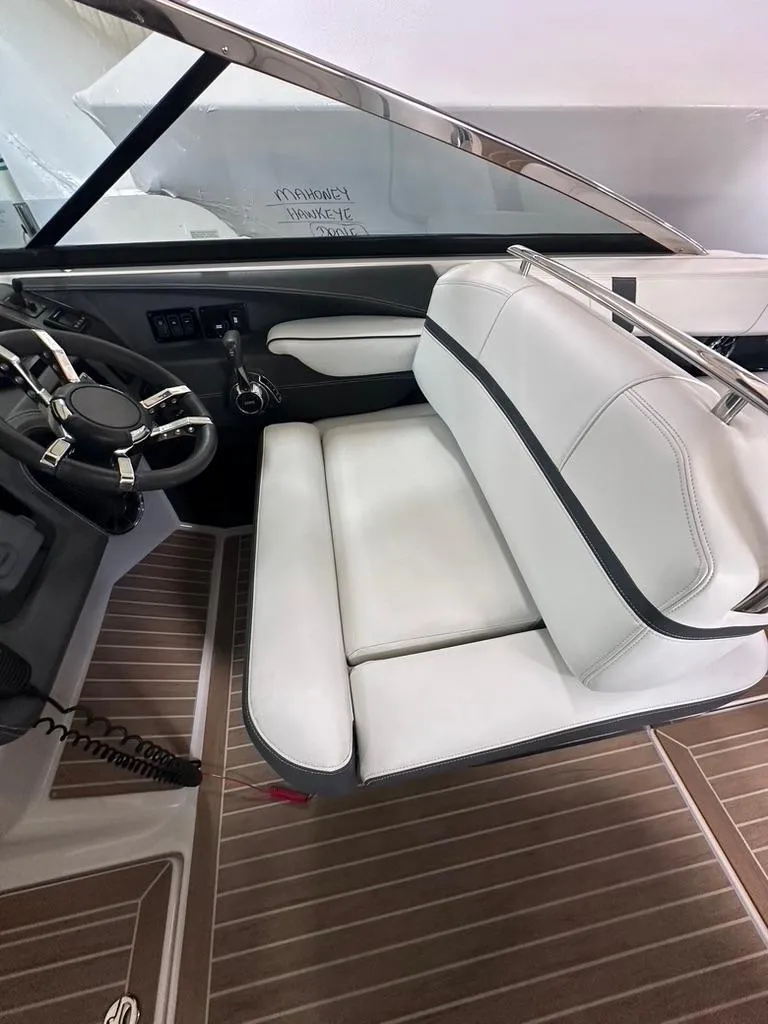 Slide: The Image of 2015 Regal 2800 Bowrider interior with white seating and sleek dashboard design. - 11